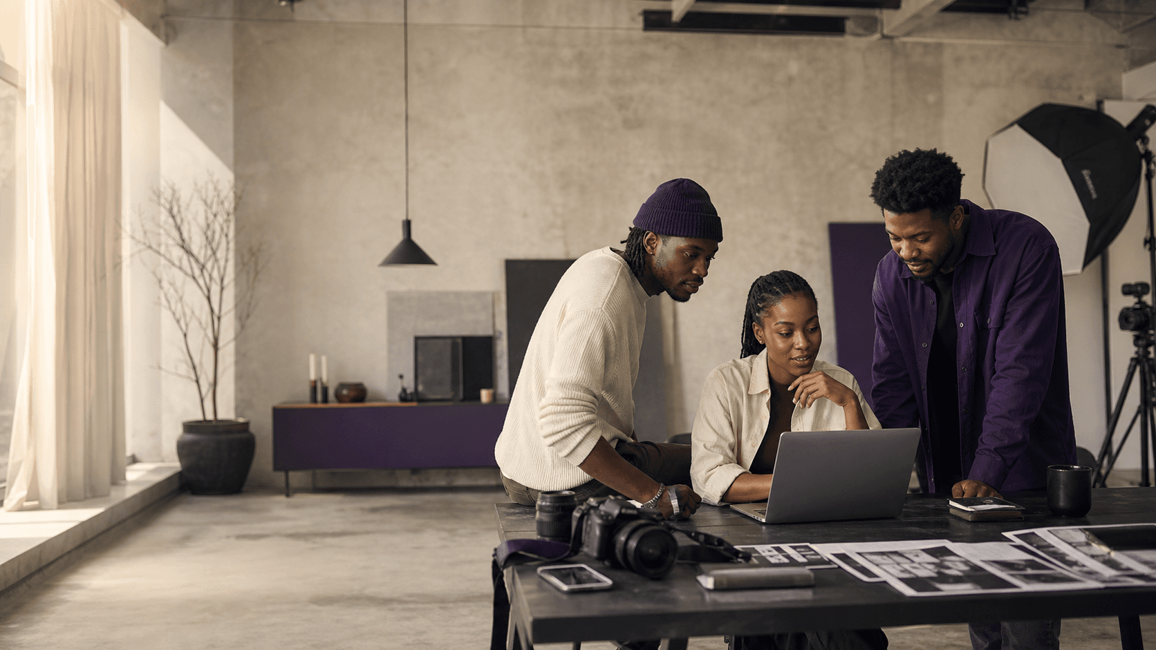 Three creators collaborating in a studio